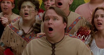 Movie still from “Heavyweights” (1995), directed by Steven Brill – A group of men in native american garb singing; Close Up shot, Low angle