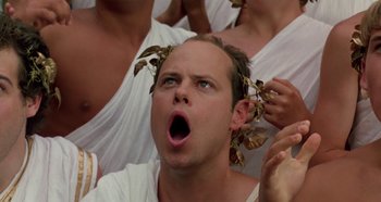 Movie still from “Heavyweights” (1995), directed by Steven Brill – A man in white shirt with leaves in his hair; Close Up shot, Low angle