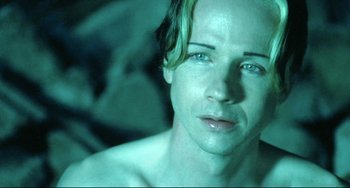 Movie still from “Hedwig and the Angry Inch” (2001), directed by John Cameron Mitchell – A person in a green light; Close Up shot, High angle