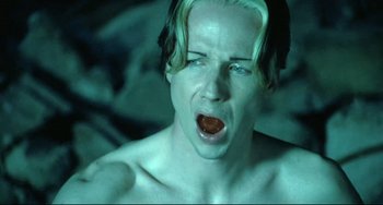 Movie still from “Hedwig and the Angry Inch” (2001), directed by John Cameron Mitchell – A shirtless man with his mouth wide open; Close Up shot, Overhead angle