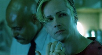 Movie still from “Hedwig and the Angry Inch” (2001), directed by John Cameron Mitchell – A person with their hands clasped together; Close Up shot, Over the shoulder angle