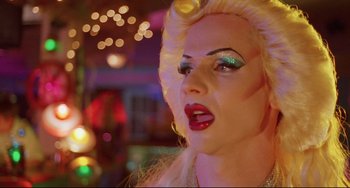 Movie still from “Hedwig and the Angry Inch” (2001), directed by John Cameron Mitchell – A drag queen with blonde hair and red lipstick; Close Up shot, Low angle
