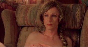 Movie still from “Hedwig and the Angry Inch” (2001), directed by John Cameron Mitchell – A woman sitting on a couch looking sad; Close Up shot, High angle