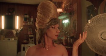Movie still from “Hedwig and the Angry Inch” (2001), directed by John Cameron Mitchell – A woman with a large blonde wig on her head; Close Up shot, Low angle