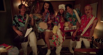 Movie still from “Hedwig and the Angry Inch” (2001), directed by John Cameron Mitchell – A group of men in hawaiian shirts playing musical instruments; Wide shot, High angle