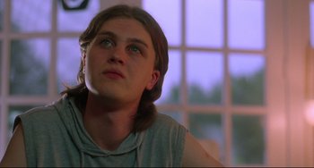 Movie still from “Hedwig and the Angry Inch” (2001), directed by John Cameron Mitchell – A young man with long brown hair looking up at the sky; Close Up shot, Low angle