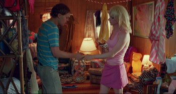 Movie still from “Hedwig and the Angry Inch” (2001), directed by John Cameron Mitchell – A man and a woman shaking hands in a room; Medium shot, Over the shoulder angle