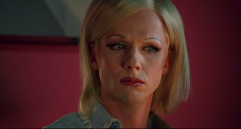 Movie still from “Hedwig and the Angry Inch” (2001), directed by John Cameron Mitchell – A person with short blonde hair; Close Up shot, High angle