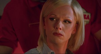 Movie still from “Hedwig and the Angry Inch” (2001), directed by John Cameron Mitchell – A person wearing a dress shirt; Close Up shot, High angle
