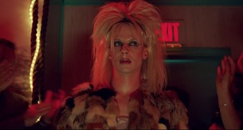 Movie still from “Hedwig and the Angry Inch” (2001), directed by John Cameron Mitchell – A woman with blonde hair is wearing a fur coat; Close Up shot, Low angle