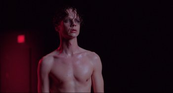 Movie still from “Hedwig and the Angry Inch” (2001), directed by John Cameron Mitchell – A man with wet hair is posing for the camera; Close Up shot, Low angle