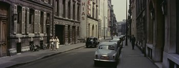 Movie still from “Hell and High Water” (1954), directed by Samuel Fuller – An old photo of a street with cars parked on the side of the road; Extreme Wide shot, High angle