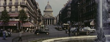 Movie still from “Hell and High Water” (1954), directed by Samuel Fuller – An old photo of a street with cars parked on the side of the road; Extreme Wide shot, High angle
