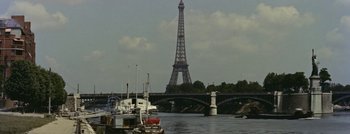 Movie still from “Hell and High Water” (1954), directed by Samuel Fuller – A boat on a river near a bridge with a tower in the background; Extreme Wide shot, Low angle