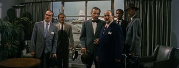 Movie still from “Hell and High Water” (1954), directed by Samuel Fuller – A group of men standing next to each other in a room; Medium shot, Low angle