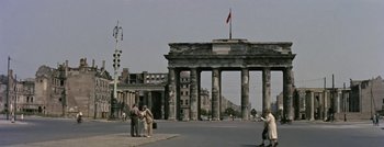 Movie still from “Hell and High Water” (1954), directed by Samuel Fuller – A group of people standing in front of a building; Extreme Wide shot, High angle