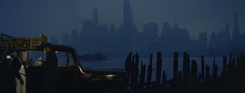 Movie still from “Hell and High Water” (1954), directed by Samuel Fuller – A view of a city skyline at night with a body of water in the background; Extreme Wide shot, Low angle