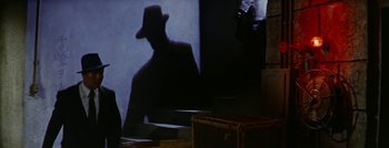 Movie still from “Hell and High Water” (1954), directed by Samuel Fuller – A shadow of a man wearing a hat; Wide shot, Over the shoulder angle