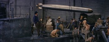 Movie still from “Hell and High Water” (1954), directed by Samuel Fuller – A group of men working on a large object; Wide shot, High angle