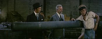 Movie still from “Hell and High Water” (1954), directed by Samuel Fuller – Two men in suits and ties standing next to each other; Medium shot, Low angle