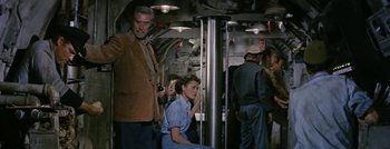 Movie still from “Hell and High Water” (1954), directed by Samuel Fuller – A man and a woman are sitting on a boat; Medium shot, High angle