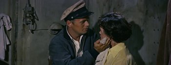 Movie still from “Hell and High Water” (1954), directed by Samuel Fuller – A man and a woman in a military uniform; Close Up shot, Over the shoulder angle