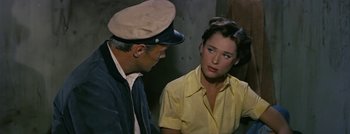 Movie still from “Hell and High Water” (1954), directed by Samuel Fuller – A man and a woman are sitting next to each other; Close Up shot, High angle