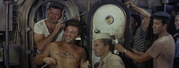 Movie still from “Hell and High Water” (1954), directed by Samuel Fuller – A group of men standing next to each other in front of a mirror; Medium shot, High angle