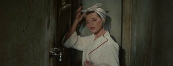 Movie still from “Hell and High Water” (1954), directed by Samuel Fuller – A woman in a white bathrobe and a towel around her head; Close Up shot, High angle