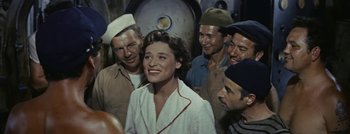 Movie still from “Hell and High Water” (1954), directed by Samuel Fuller – A group of men and women standing next to each other; Medium shot, High angle