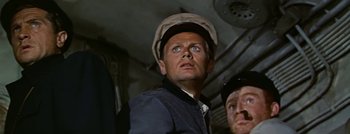 Movie still from “Hell and High Water” (1954), directed by Samuel Fuller – A man wearing a hat looking up at the sky; Close Up shot, Low angle
