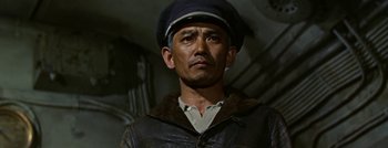 Movie still from “Hell and High Water” (1954), directed by Samuel Fuller – A man wearing a leather jacket and a hat; Medium shot, Low angle