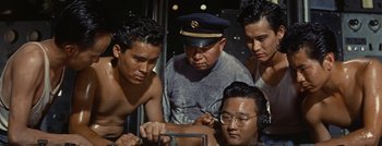 Movie still from “Hell and High Water” (1954), directed by Samuel Fuller – A group of men standing next to each other in a room; Medium shot, High angle