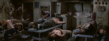 Movie still from “Hell and High Water” (1954), directed by Samuel Fuller – Two men laying down in a garage; Wide shot, High angle