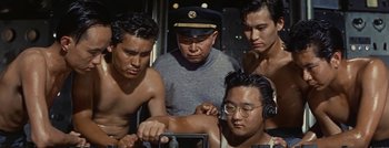 Movie still from “Hell and High Water” (1954), directed by Samuel Fuller – A group of men standing next to each other in a room; Medium shot, Low angle