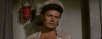 Movie still from “Hell and High Water” (1954), directed by Samuel Fuller – A person wearing a hat; Close Up shot, High angle