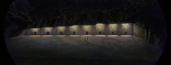 Movie still from “Hell and High Water” (1954), directed by Samuel Fuller – Two people are standing in the middle of an empty field at night; Extreme Wide shot, Overhead angle