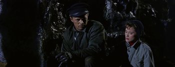 Movie still from “Hell and High Water” (1954), directed by Samuel Fuller – A man wearing a black hat and a green jacket; Medium shot, High angle