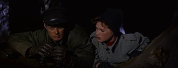 Movie still from “Hell and High Water” (1954), directed by Samuel Fuller – A man and a woman sitting next to each other in the dark; Close Up shot, High angle