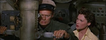 Movie still from “Hell and High Water” (1954), directed by Samuel Fuller – A man in a military uniform holding a wrench; Close Up shot, High angle