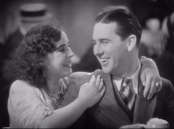 Movie still from “Hell's Angels” (1930), directed by Edmund Goulding – An old photo of a man and a woman smiling for the camera; Close Up shot, High angle
