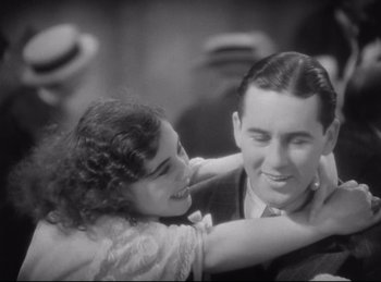 Movie still from “Hell's Angels” (1930), directed by Edmund Goulding – A man and a woman are hugging in a black and white photo; Close Up shot, High angle