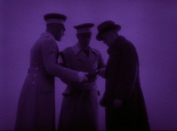 Movie still from “Hell's Angels” (1930), directed by Edmund Goulding – A group of men standing next to each other; Wide shot, Low angle