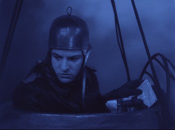 Movie still from “Hell's Angels” (1930), directed by Edmund Goulding – A man wearing a helmet is looking at something; Medium shot, Low angle