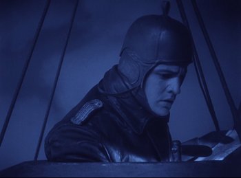 Movie still from “Hell's Angels” (1930), directed by Edmund Goulding – A man wearing a leather jacket and a helmet; Medium shot, Low angle