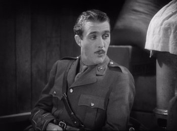 Movie still from “Hell's Angels” (1930), directed by Edmund Goulding – A man in a military uniform sitting in a chair; Close Up shot, Low angle