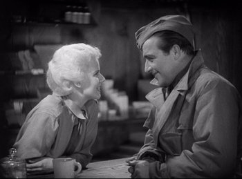 Movie still from “Hell's Angels” (1930), directed by Edmund Goulding – An old photo of a man and a woman talking to each other; Medium shot, High angle