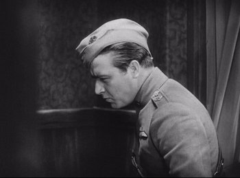 Movie still from “Hell's Angels” (1930), directed by Edmund Goulding – An old photo of a man in a military uniform; Medium shot, Low angle