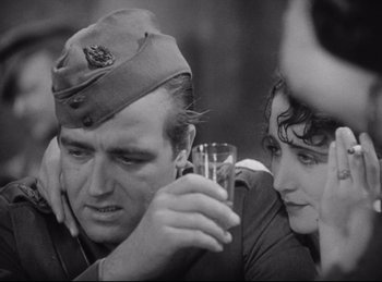 Movie still from “Hell's Angels” (1930), directed by Edmund Goulding – A man and a woman holding a wine glass in their hands; Close Up shot, Low angle