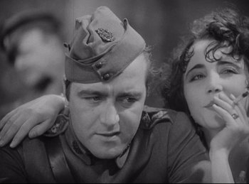 Movie still from “Hell's Angels” (1930), directed by Edmund Goulding – A man and a woman are sitting together; Close Up shot, Low angle